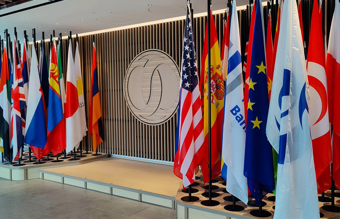 numerous international flags next to a podium stage